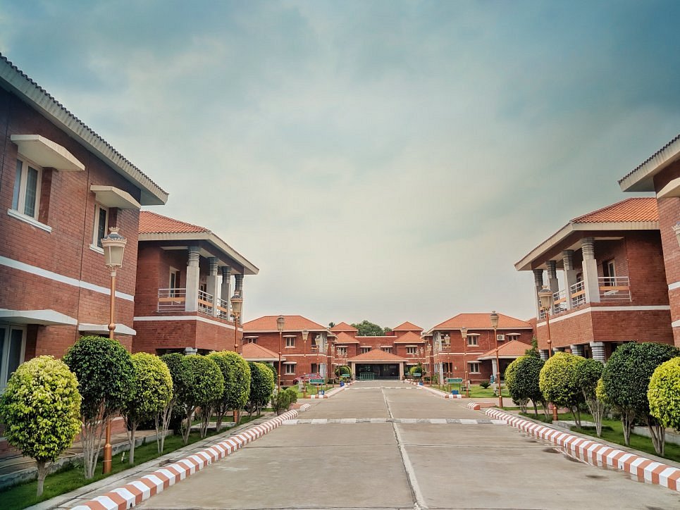 Tree-lined avenue between red-brick guest house blocks